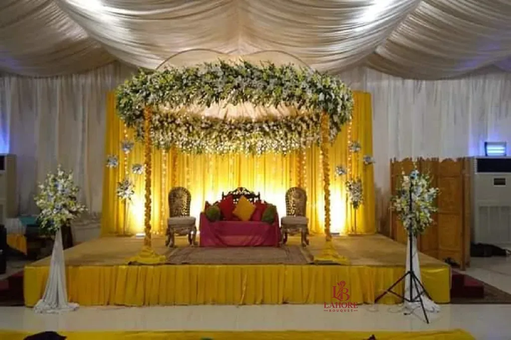 Elegant Floral Mandap with Traditional Yellow and White Wedding Backdrop