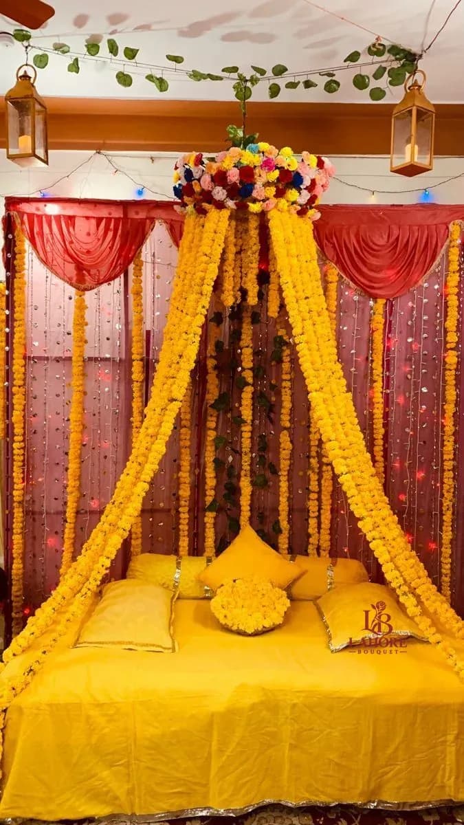 Elegant Mayo Floral Setup with Marigold Drapes and Traditional Pillows